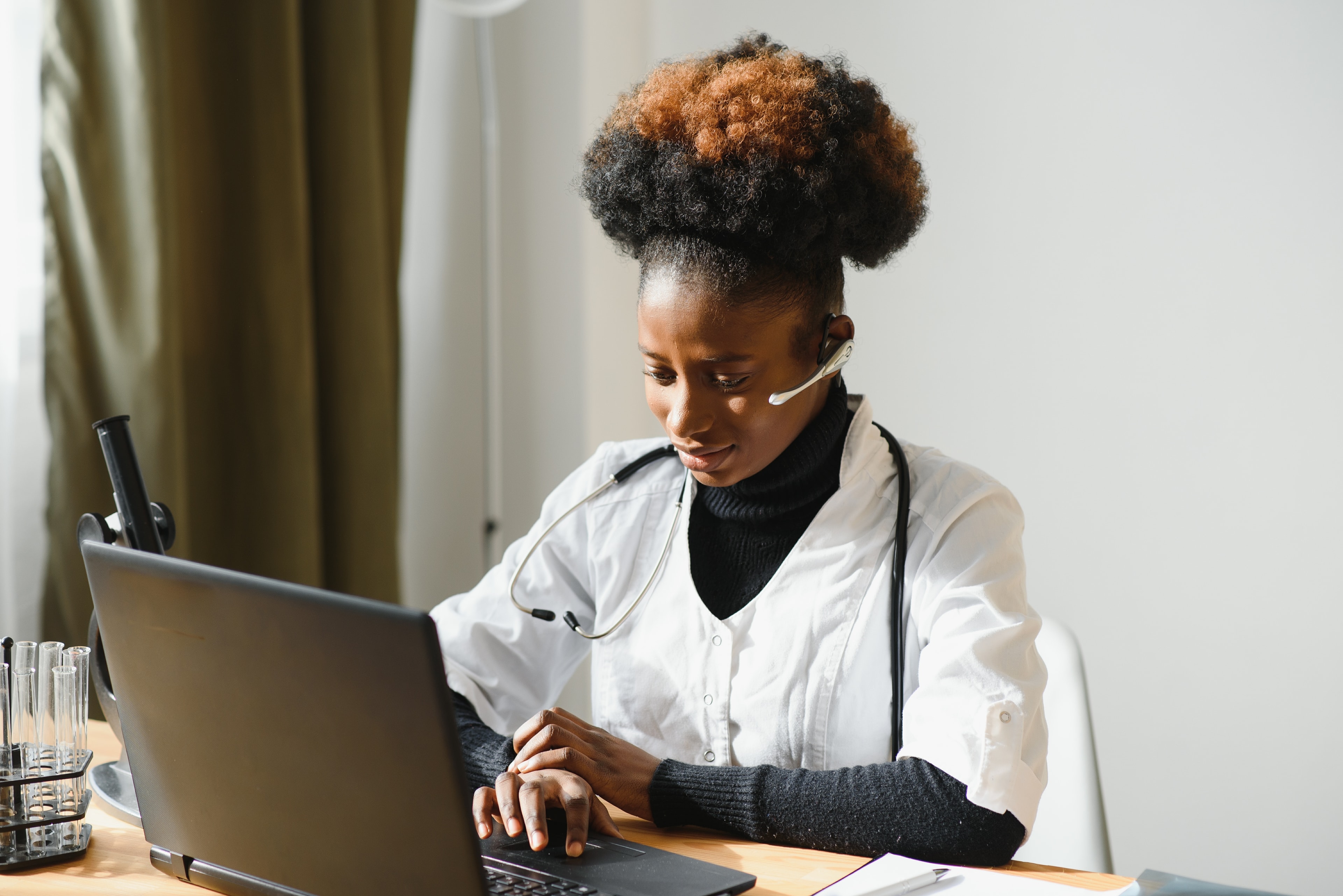 A healthcare professional working at her laptop